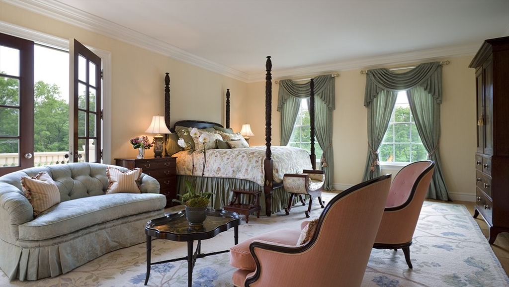 495 Hugh Cargill Road Concord, MA 01742 - Photo 35 of 42 a living room with furniture fireplace and large windows
