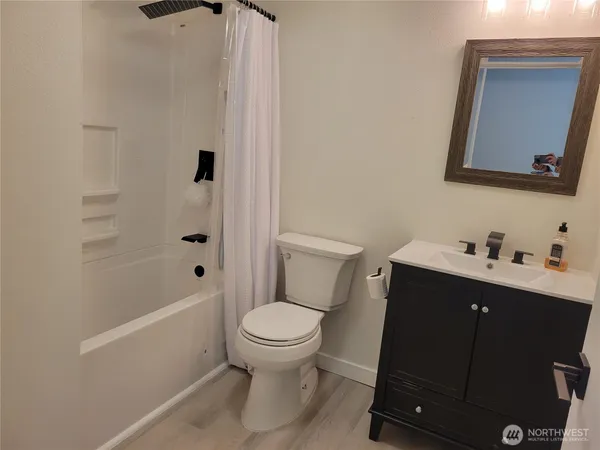 a bathroom with a toilet sink and mirror
