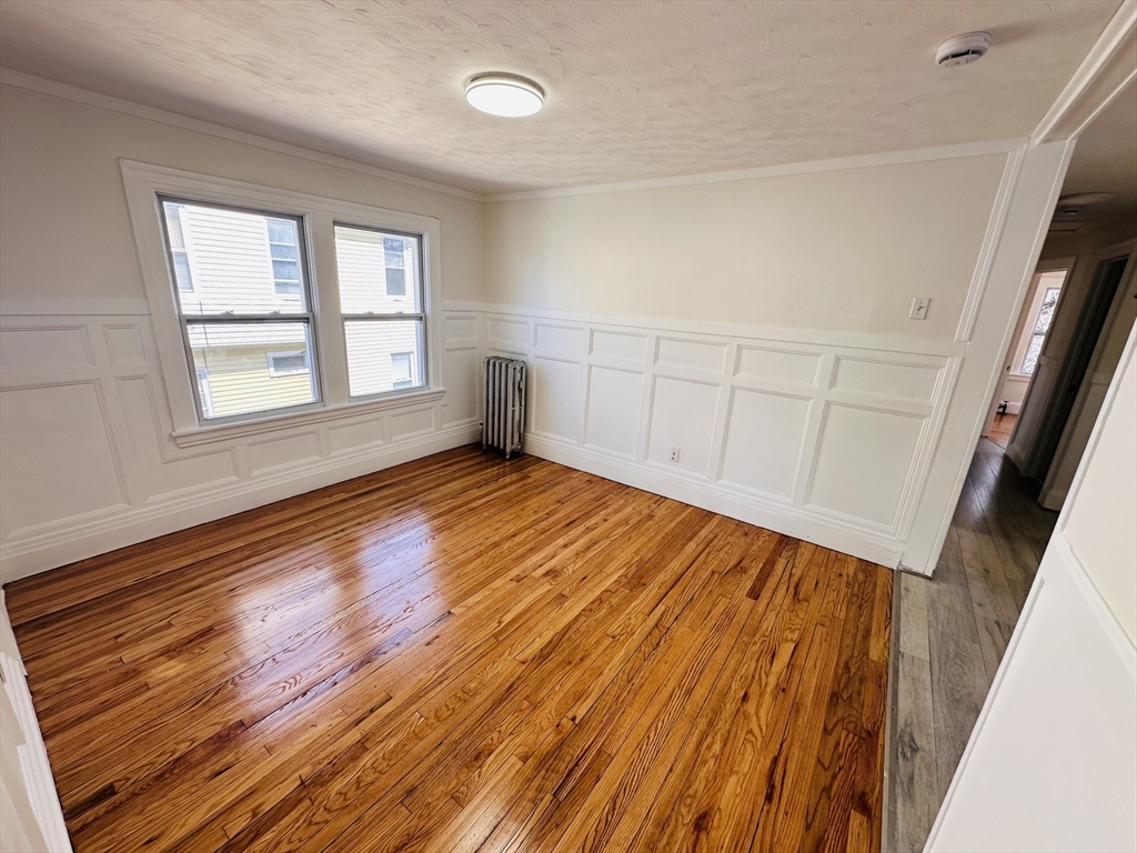 35-37 Suffolk Street Springfield, MA 01109 - Photo 11 of 17 a view of an empty room with wooden floor and a window