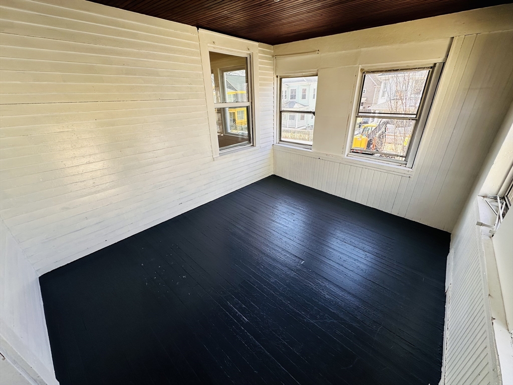 35-37 Suffolk Street Springfield, MA 01109 - Photo 16 of 17 a view of an empty room with wooden floor and a window