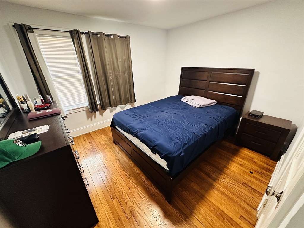 35-37 Suffolk Street Springfield, MA 01109 - Photo 6 of 17 a bedroom with a bed and a dresser