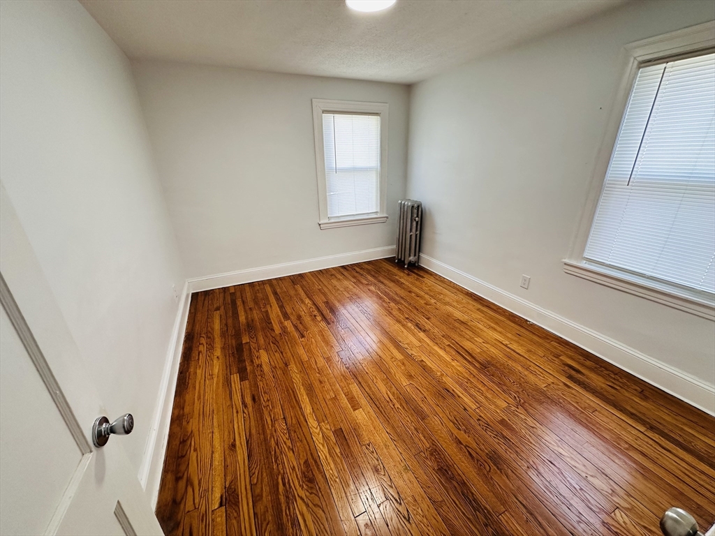 35-37 Suffolk Street Springfield, MA 01109 - Photo 8 of 17 a view of an empty room and wooden floor