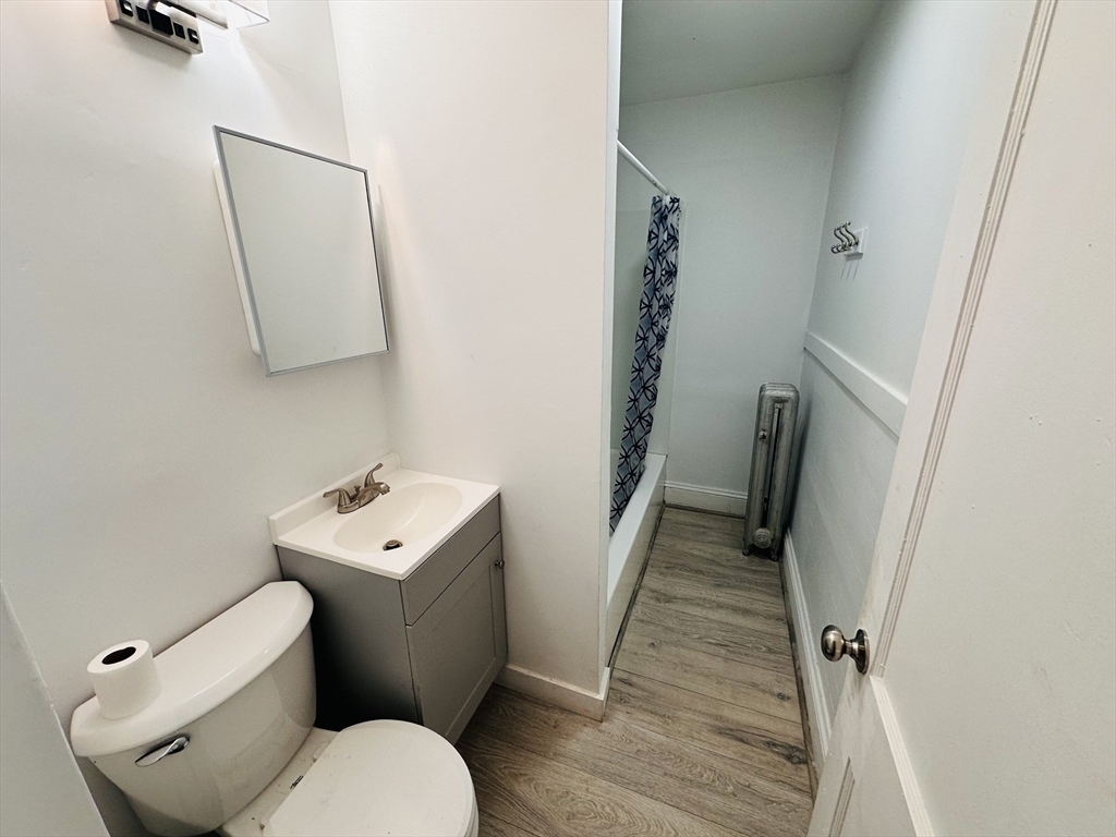 35-37 Suffolk Street Springfield, MA 01109 - Photo 9 of 17 a bathroom with a toilet sink and mirror