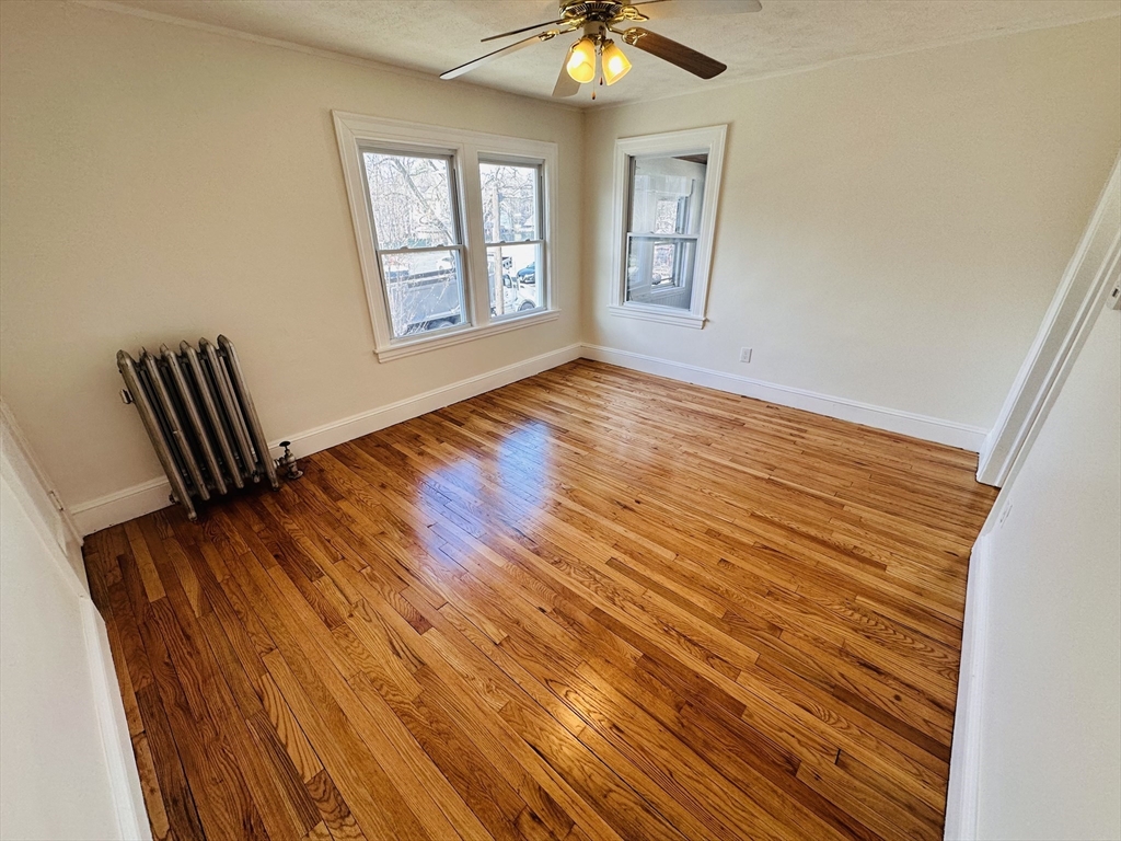 35-37 Suffolk Street Springfield, MA 01109 - Photo 10 of 17 a view of an empty room with wooden floor and a window