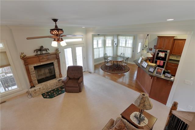 302 Barbara Spears Road Morrison, TN 37357 - Photo 2 of 16 a living room with furniture a chandelier and a fireplace
