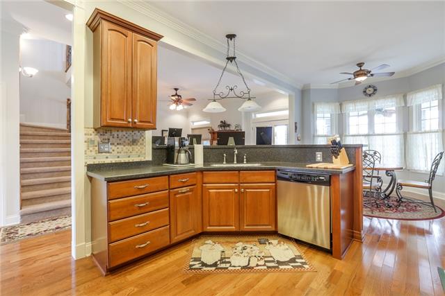 302 Barbara Spears Road Morrison, TN 37357 - Photo 5 of 16 a large kitchen with kitchen island granite countertop a sink a stove and a wooden floors