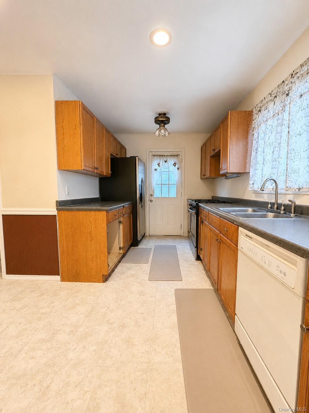 863 North Street Peekskill, NY 10566 - Photo 10 of 25 Spacious kitchen with plenty of countertops and cabinets. Door to exterior yard.
