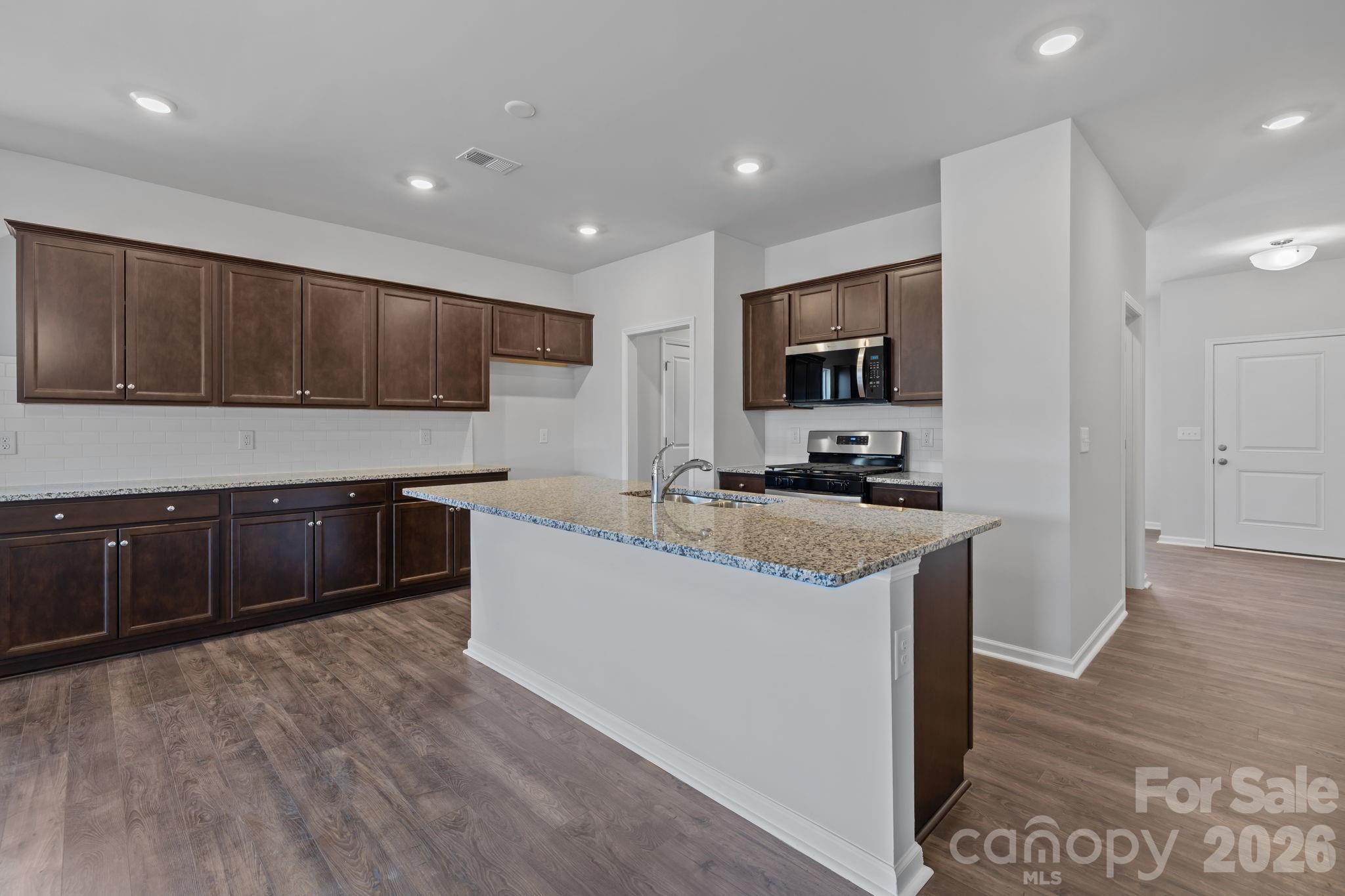 454 Brick House Road York, SC 29745 - Photo 14 of 35 a large kitchen with stainless steel appliances granite countertop a stove a sink and a refrigerator