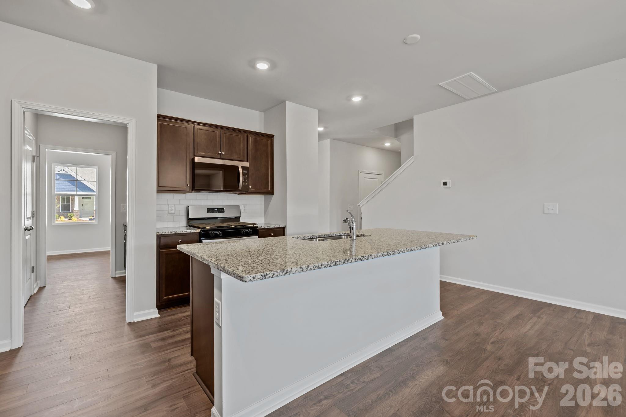 454 Brick House Road York, SC 29745 - Photo 15 of 35 a large kitchen with a sink and a stove top oven