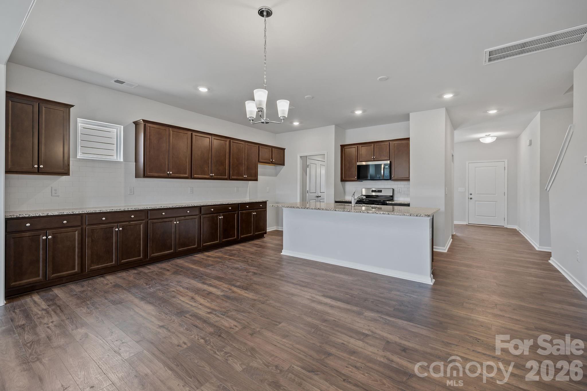 454 Brick House Road York, SC 29745 - Photo 16 of 35 a large kitchen with kitchen island a large counter top stainless steel appliances and cabinets