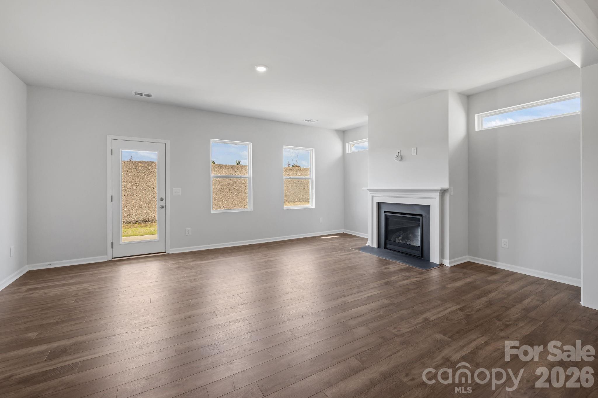 454 Brick House Road York, SC 29745 - Photo 17 of 35 a view of empty room with wooden floor and fireplace