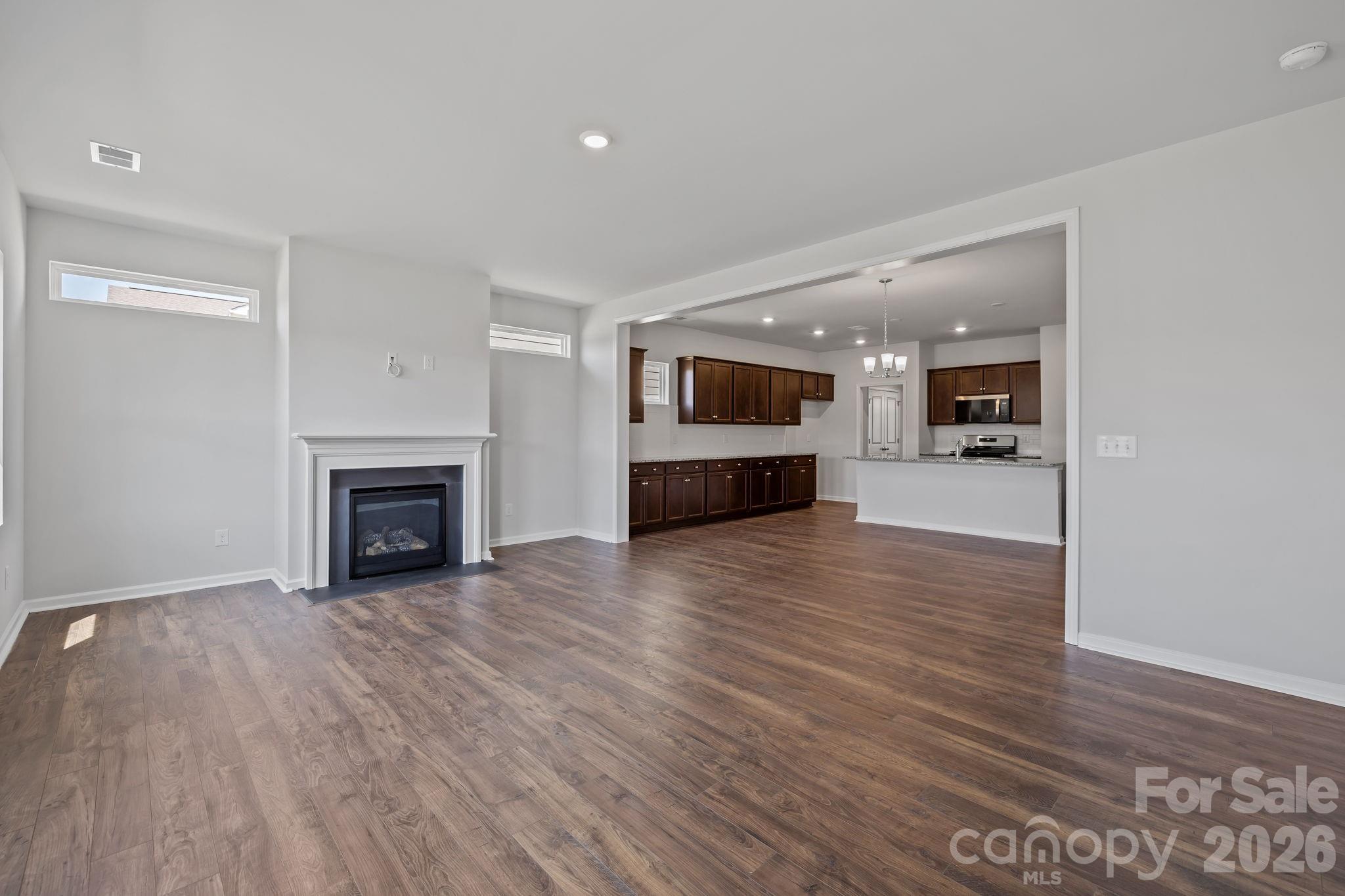 454 Brick House Road York, SC 29745 - Photo 18 of 35 a view of a livingroom with a fireplace a fireplace and wooden floor