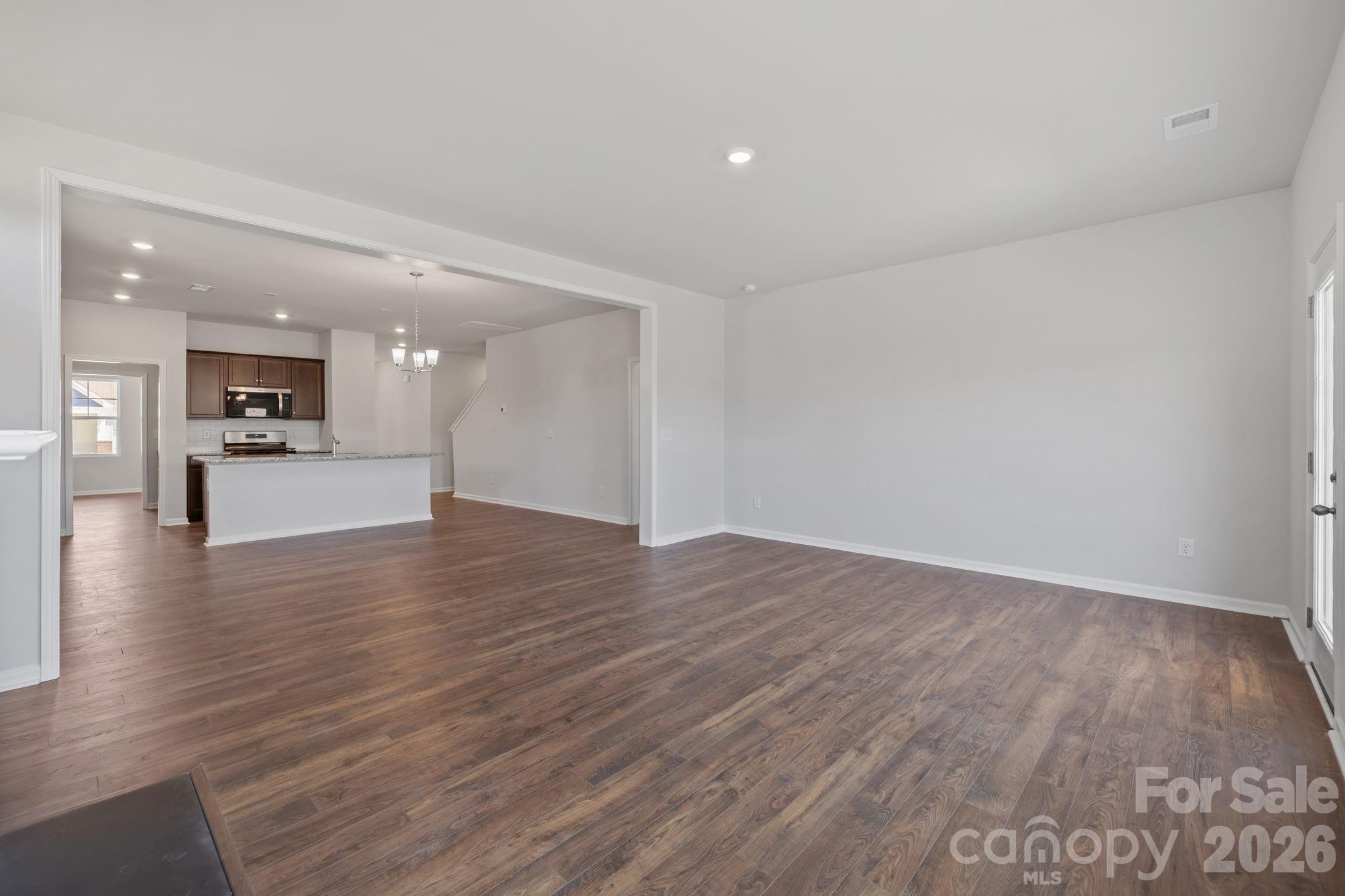 454 Brick House Road York, SC 29745 - Photo 19 of 35 a view of an empty room with wooden floor and a kitchen