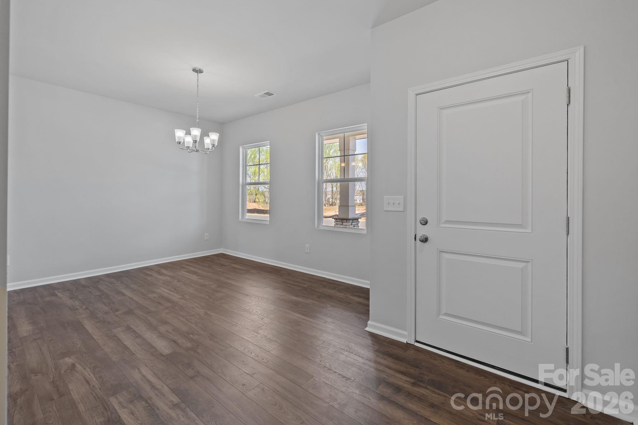 454 Brick House Road York, SC 29745 - Photo 8 of 35 an empty room with wooden floor cabinet and windows