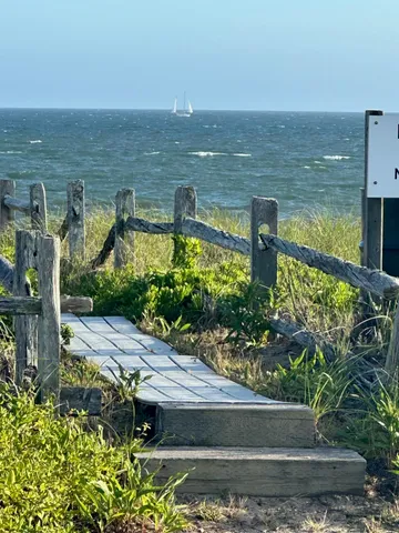 a view of a lake with a floor to ceiling window next to a building