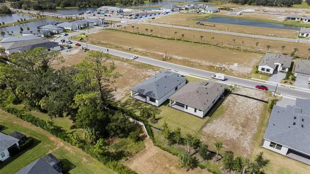 an aerial view of residential houses with outdoor space