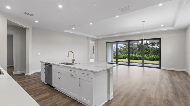 a view of room with wooden floor and fan