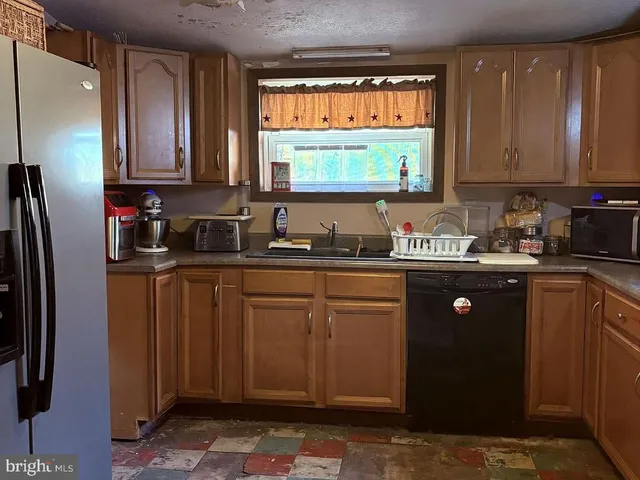 a kitchen with a refrigerator and a sink