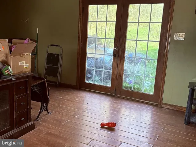a view of room with window and wooden floor