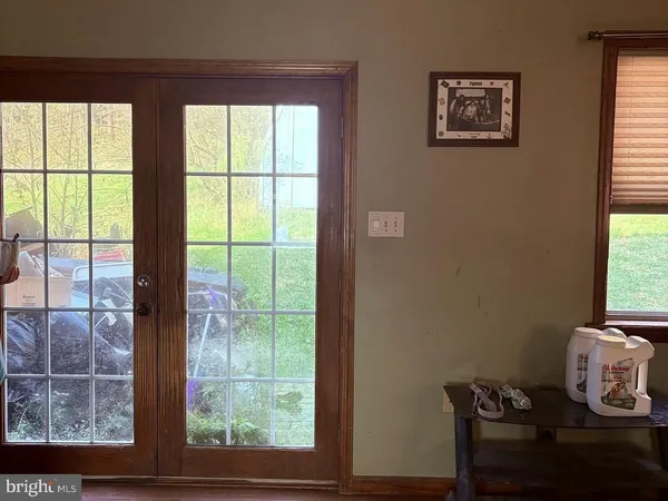 a view of a workspace room with furniture and window