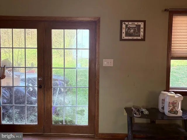 a view of a workspace room with furniture and window