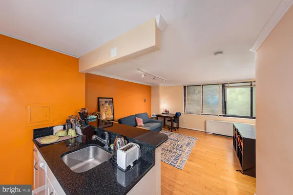 a kitchen with stainless steel appliances granite countertop a sink and a refrigerator
