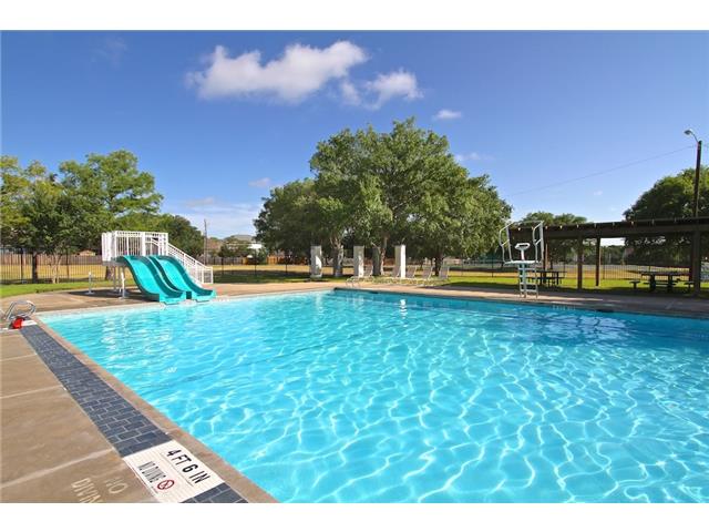 7006 Rambollet Terrace Round Rock, TX 78681 - Photo 35 of 38 Splash into summer fun with this refreshing community pool, featuring dual slides and ample shaded relaxation.