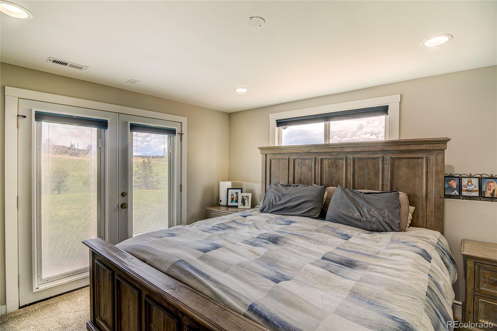 4531 East Best Road Larkspur, CO 80118 - Photo 13 of 49 a bedroom with a bed and a dresser