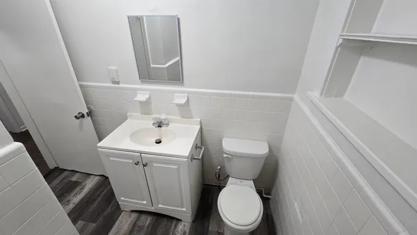 a white toilet sitting next to a white sink