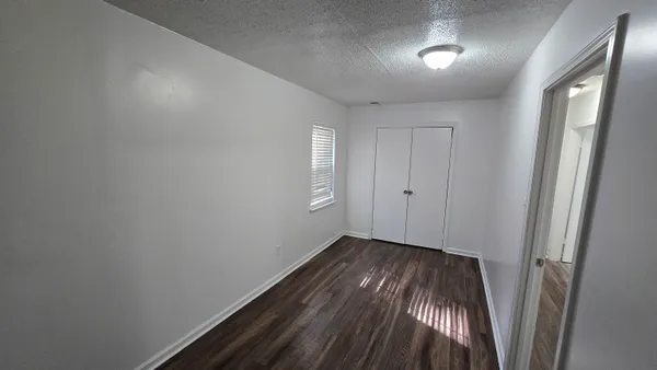 a view of hallway with wooden floor