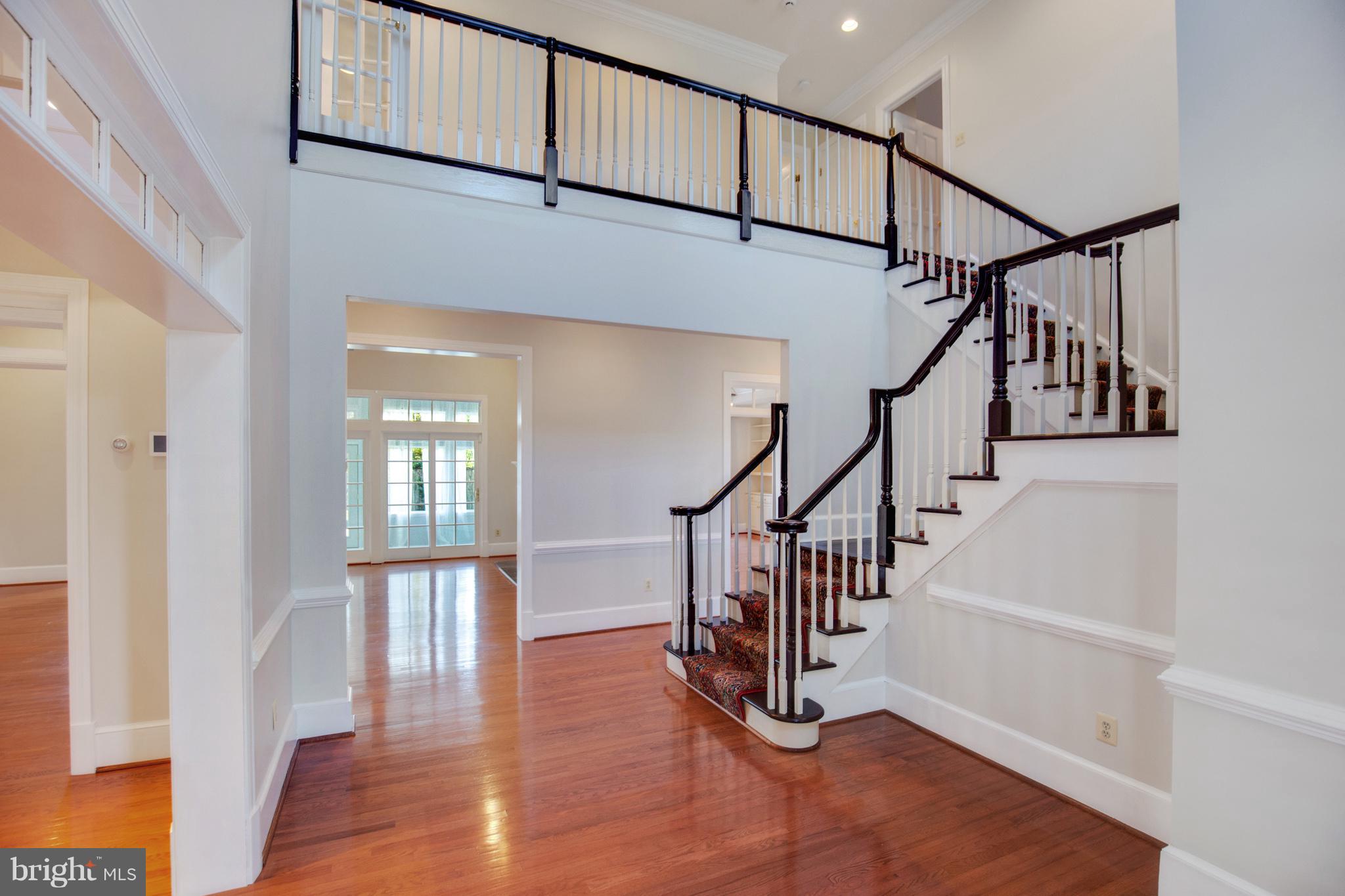14270 Solomons Island Road South Solomons, MD 20688 - Photo 2 of 30 a view of entryway with wooden floor and stairs
