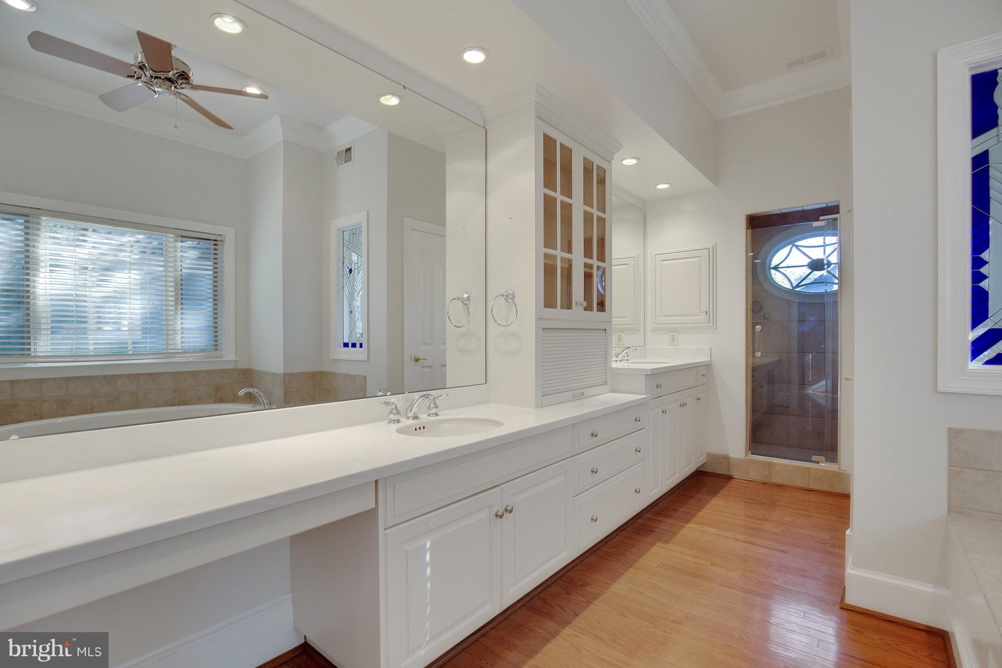 14270 Solomons Island Road South Solomons, MD 20688 - Photo 16 of 30 a spacious bathroom with a double vanity sink a mirror and a shower