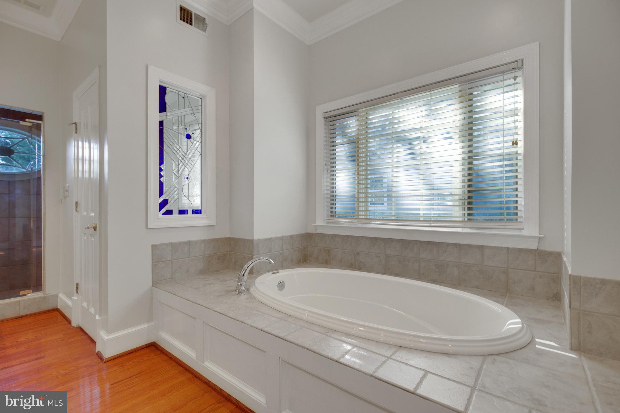 14270 Solomons Island Road South Solomons, MD 20688 - Photo 17 of 30 a bathroom with a bathtub and a shower
