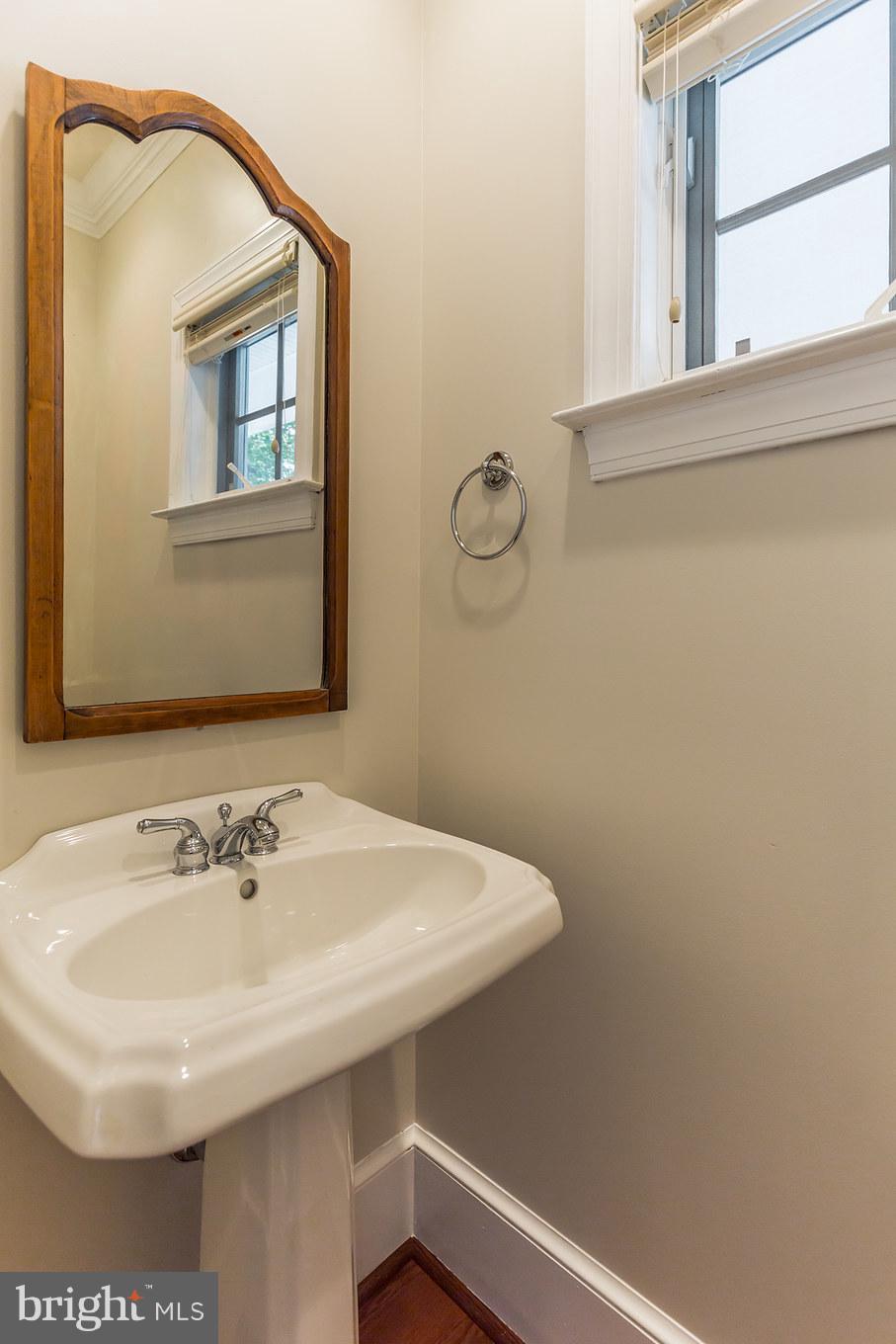 14270 Solomons Island Road South Solomons, MD 20688 - Photo 20 of 30 a bathroom with a sink and a mirror