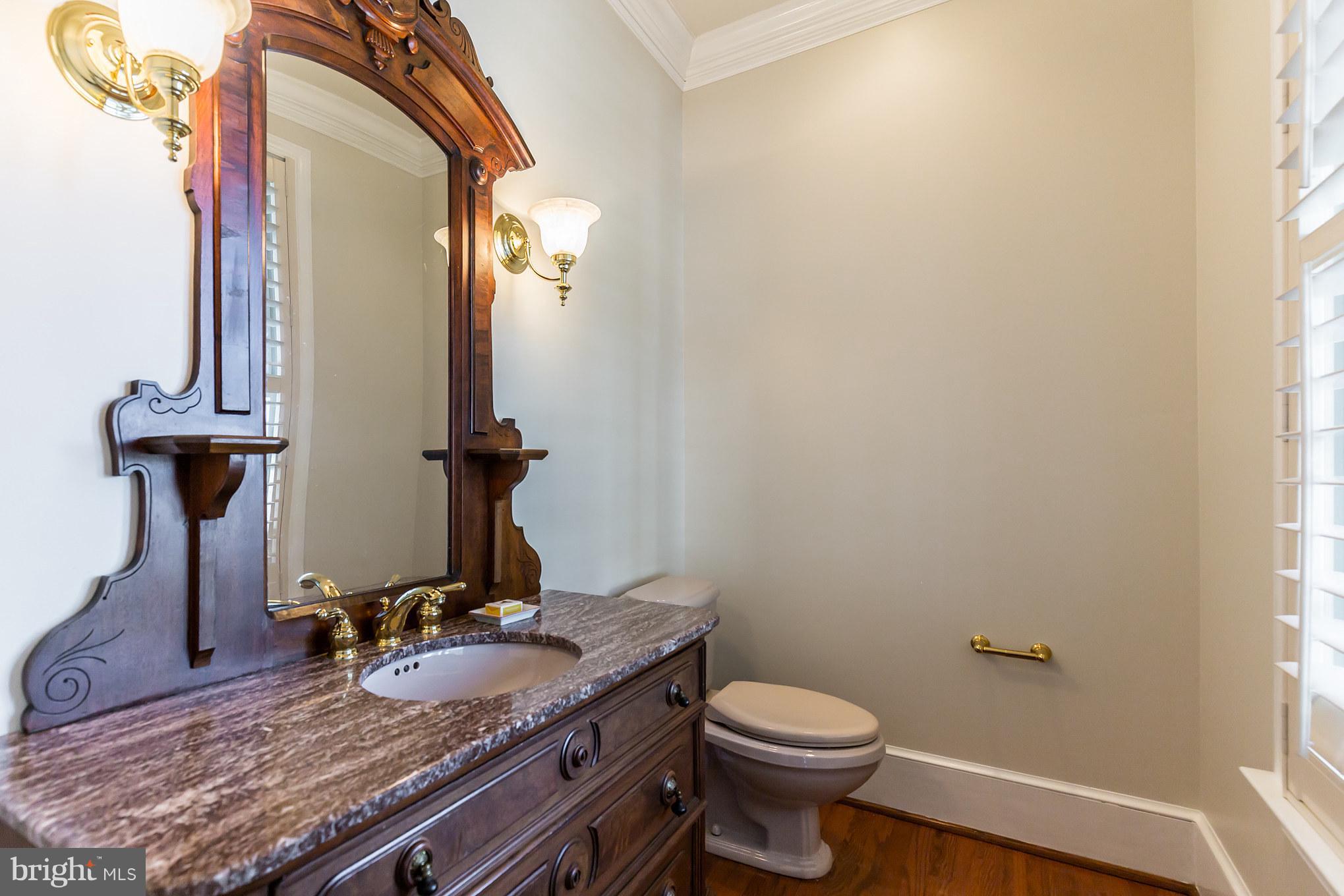 14270 Solomons Island Road South Solomons, MD 20688 - Photo 21 of 30 a bathroom with a granite countertop sink a toilet and a mirror