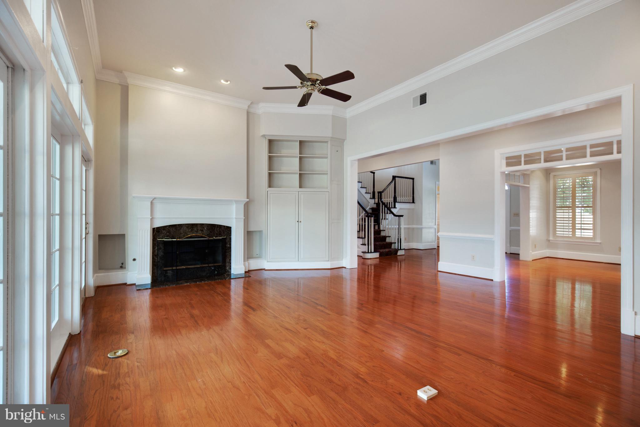 14270 Solomons Island Road South Solomons, MD 20688 - Photo 6 of 30 a view of empty room with wooden floor and fireplace