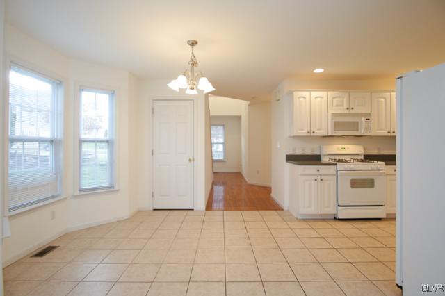 4162 Walter Road Bethlehem, PA 18020 - Photo 11 of 35 a view of a kitchen with a sink and dishwasher a refrigerator with white cabinets