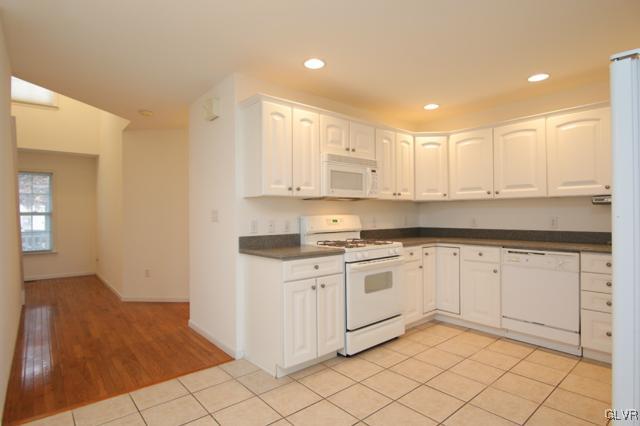 4162 Walter Road Bethlehem, PA 18020 - Photo 13 of 35 a kitchen with granite countertop white cabinets white appliances with a sink and dishwasher