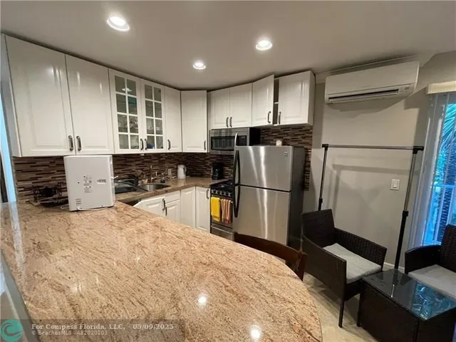 a kitchen with refrigerator and window