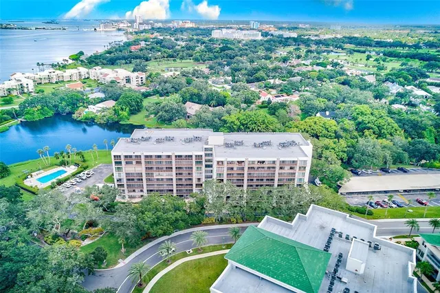 an aerial view of a house with a garden and lake view