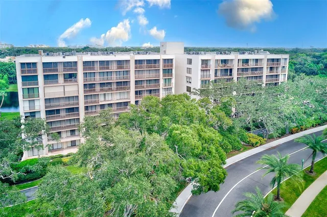 an aerial view of a house with outdoor space pool patio and lake view