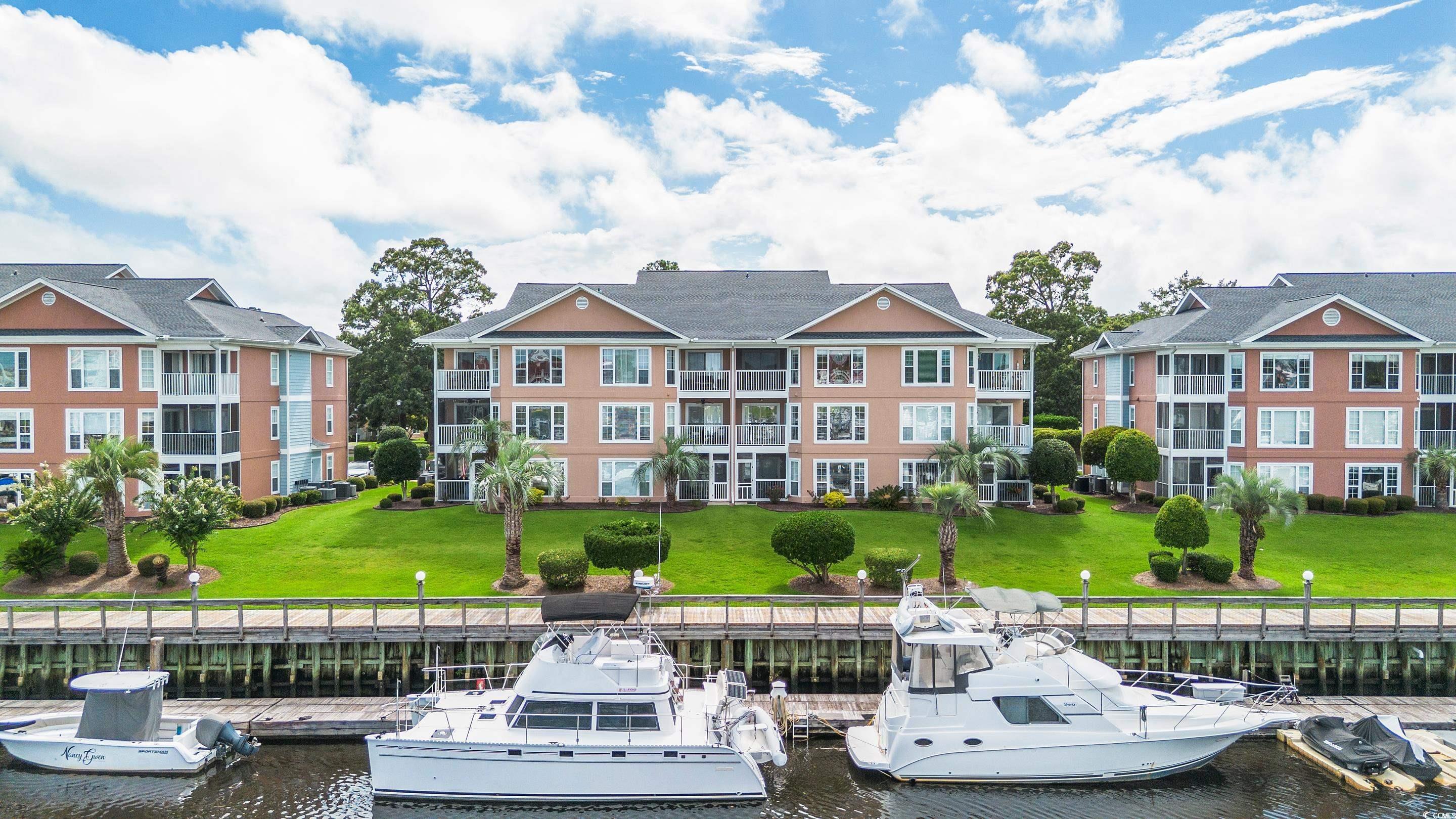 Dock area featuring a yard and a water view