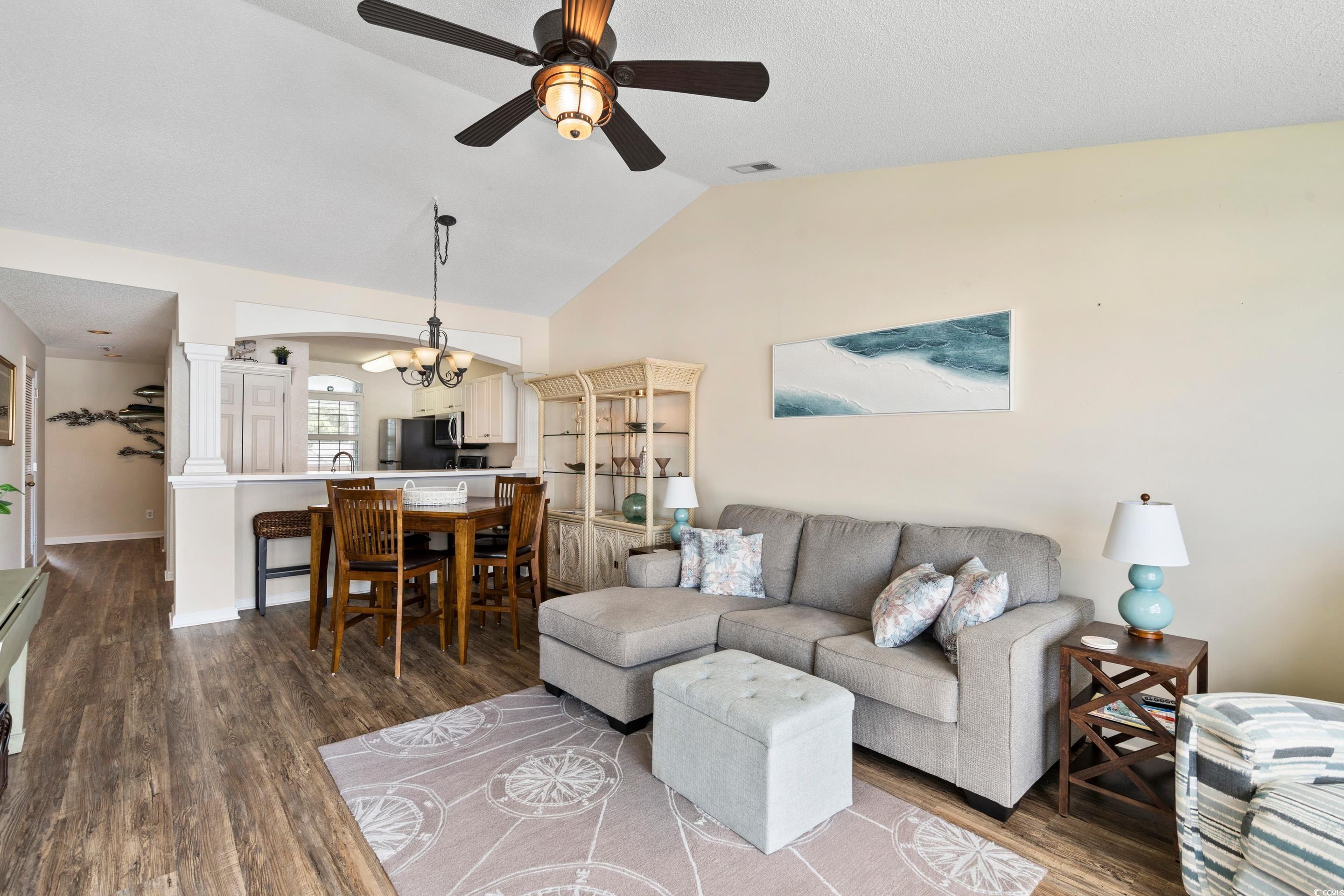 4629 Lightkeepers Way, Unit 6L Little River, SC 29566 - Photo 12 of 36 Living room with dark wood finished floors, a ceiling fan, and high vaulted ceiling