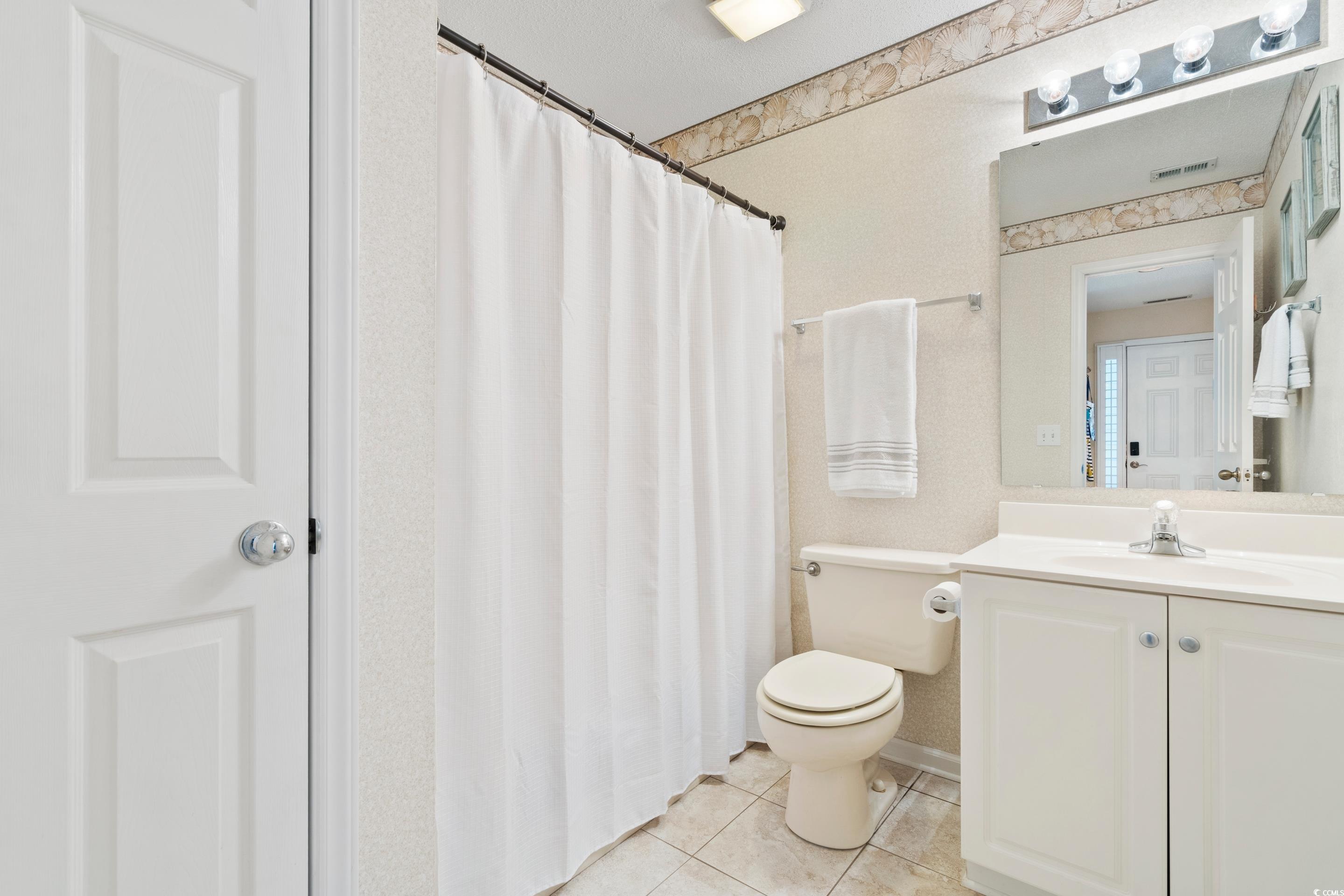 4629 Lightkeepers Way, Unit 6L Little River, SC 29566 - Photo 26 of 36 Bathroom featuring light tile patterned floors, vanity, and curtained shower