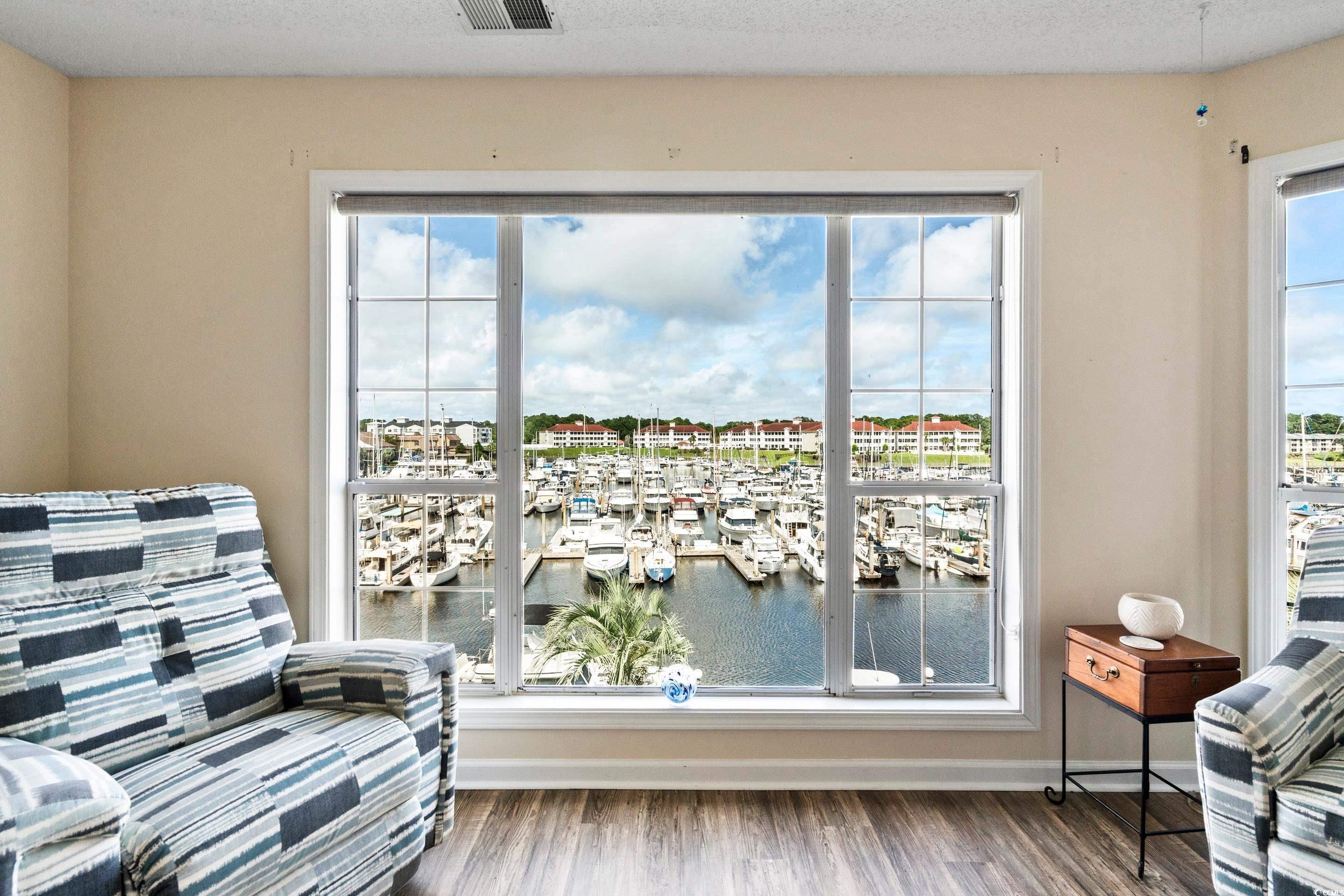 4629 Lightkeepers Way, Unit 6L Little River, SC 29566 - Photo 27 of 36 Sitting room with view of marina, wood finished floors, a water view, plenty of natural light, and a textured ceiling