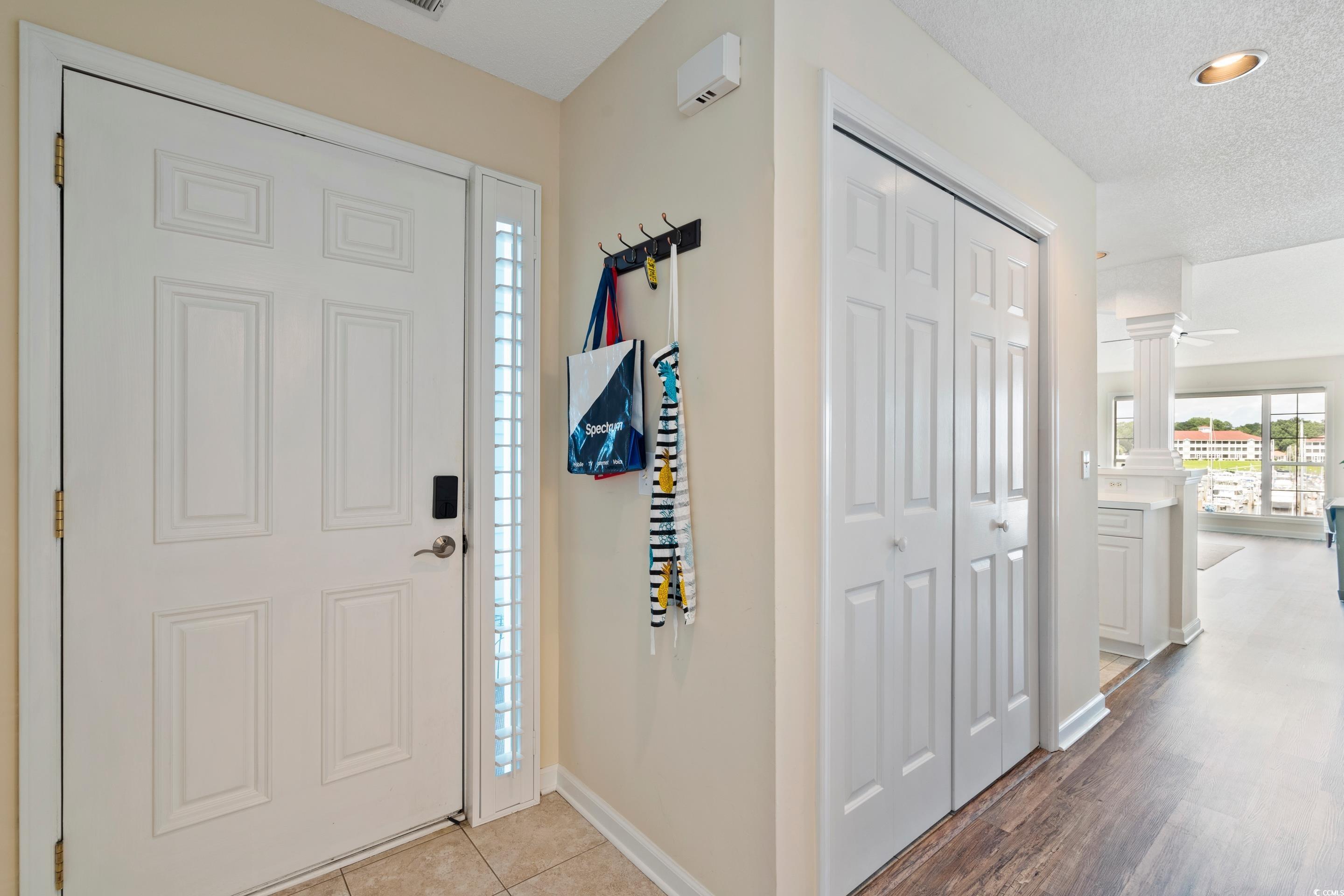 4629 Lightkeepers Way, Unit 6L Little River, SC 29566 - Photo 6 of 36 Entrance foyer with ornate columns, a textured ceiling, and tile patterned floors