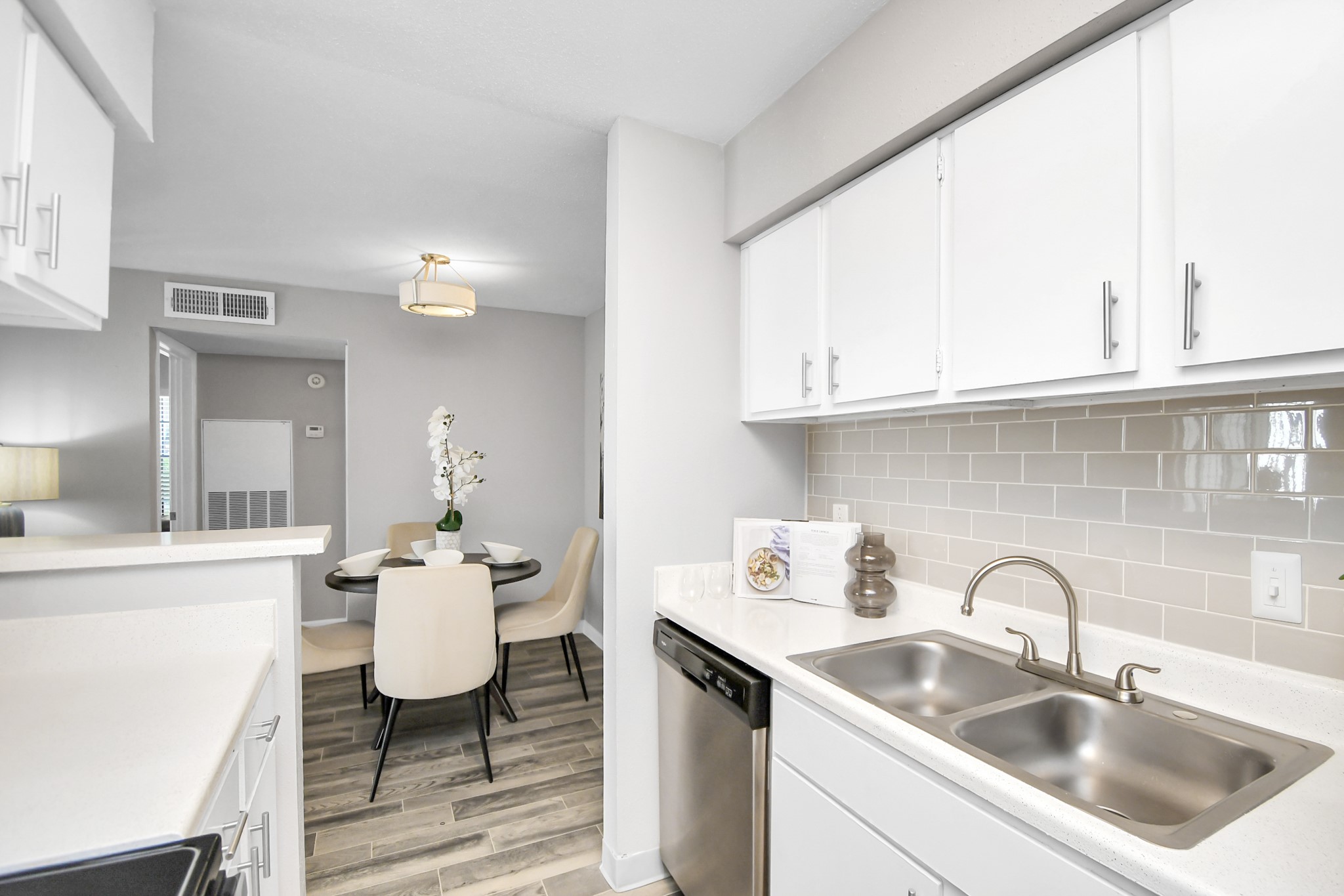 2701 West Bellfort Avenue, Unit 1004 Houston, TX 77054 - Photo 13 of 44 a kitchen with a sink cabinets and dining table