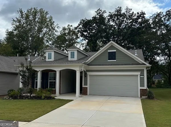 a front view of a house with a yard and garage