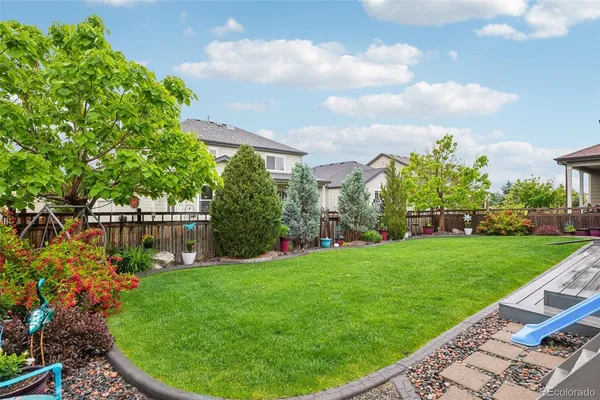 a front view of a house with yard and green space