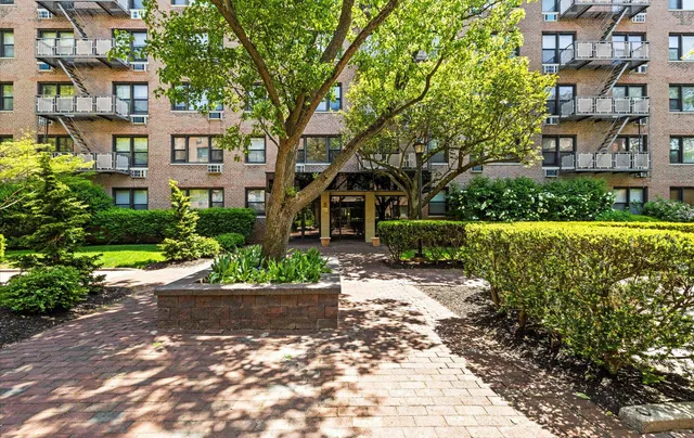 a view of a building with garden and trees
